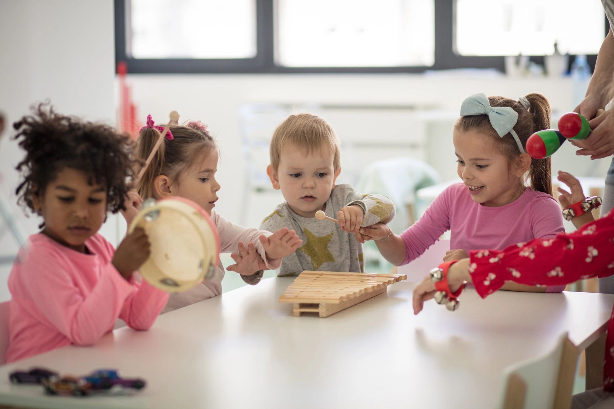 Children making music and playing together in preschool