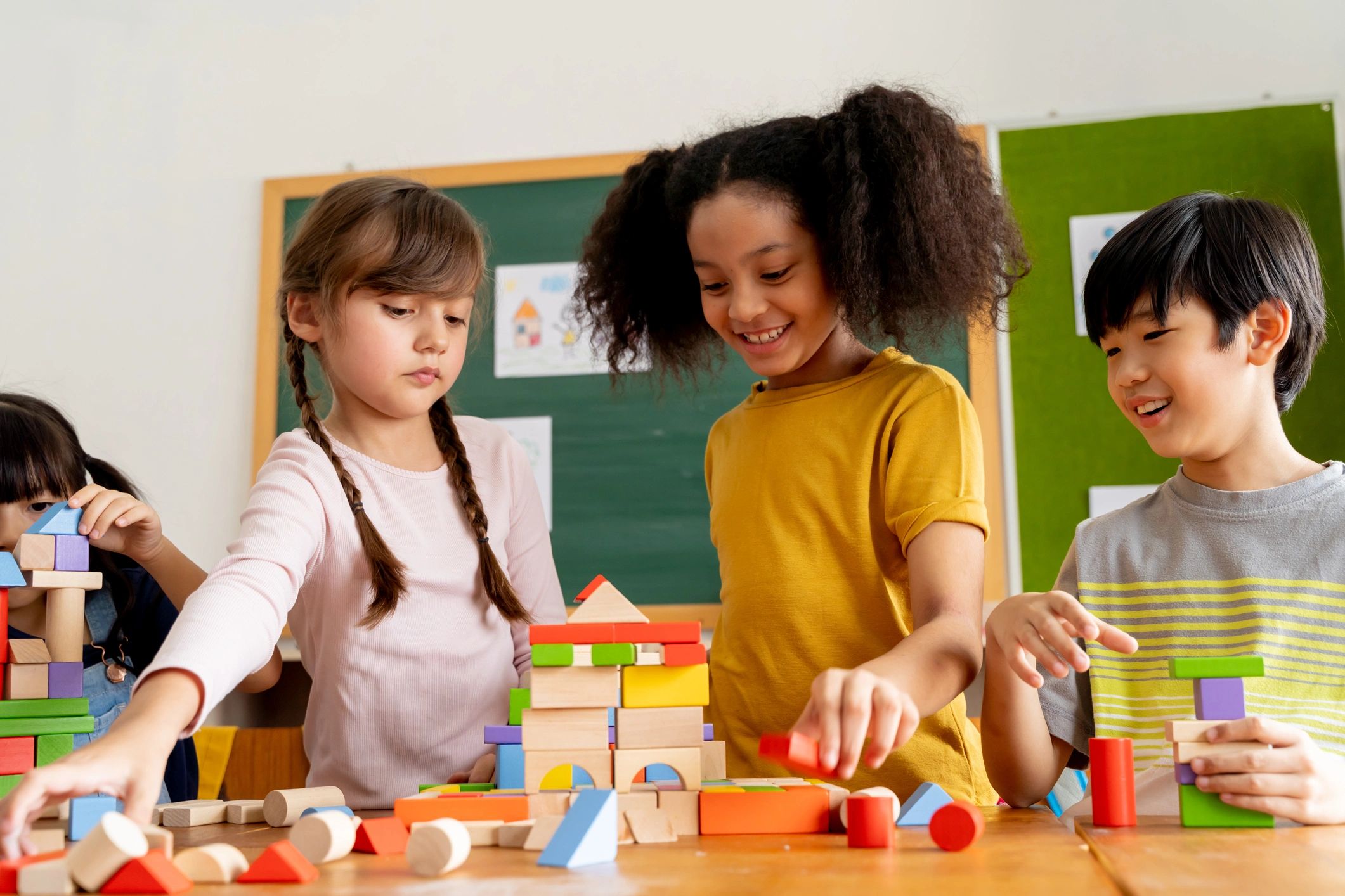 Children collaborating and playing with blocks in a classroom