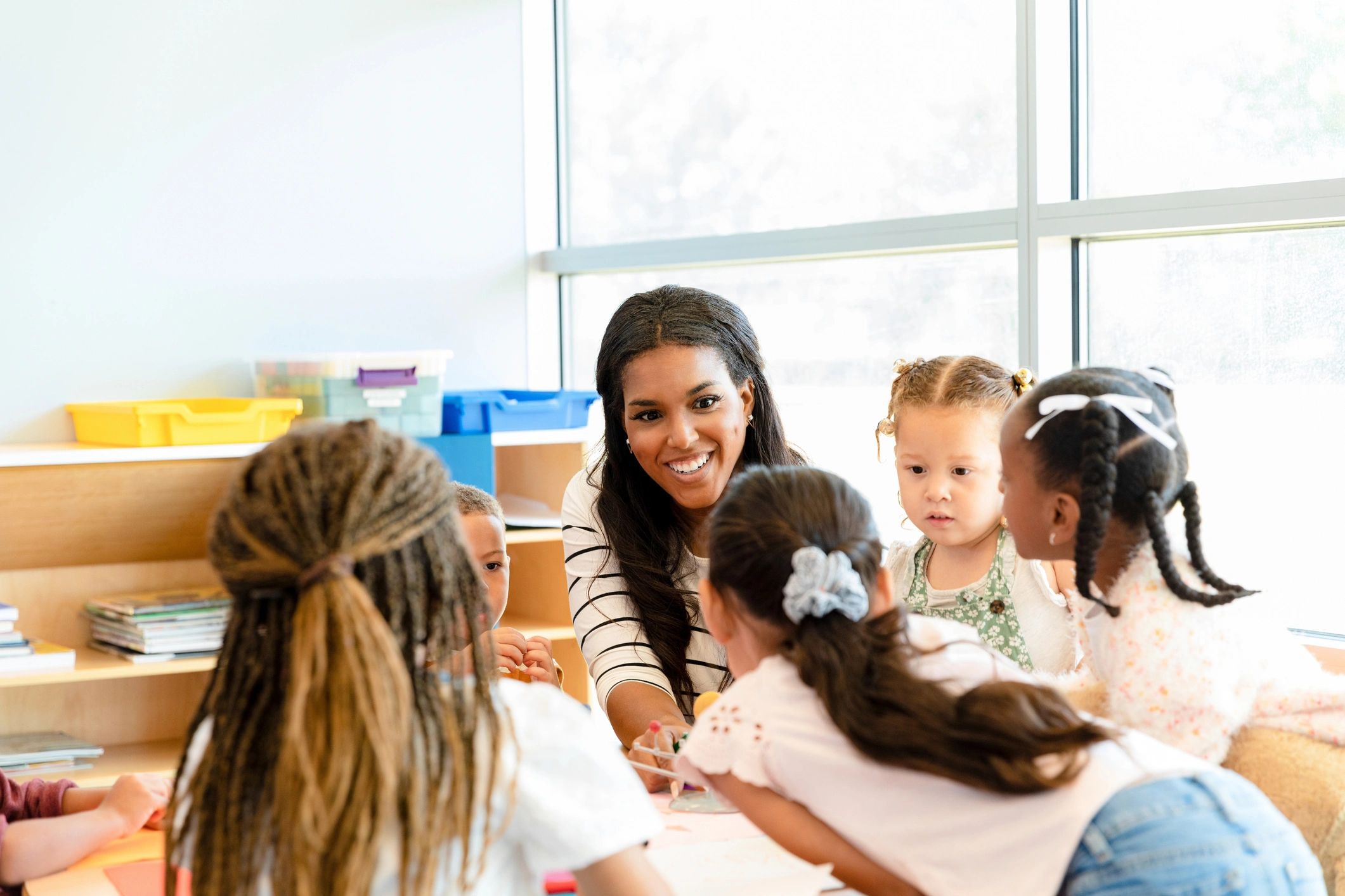 Preschool teacher teaching children in a classroom