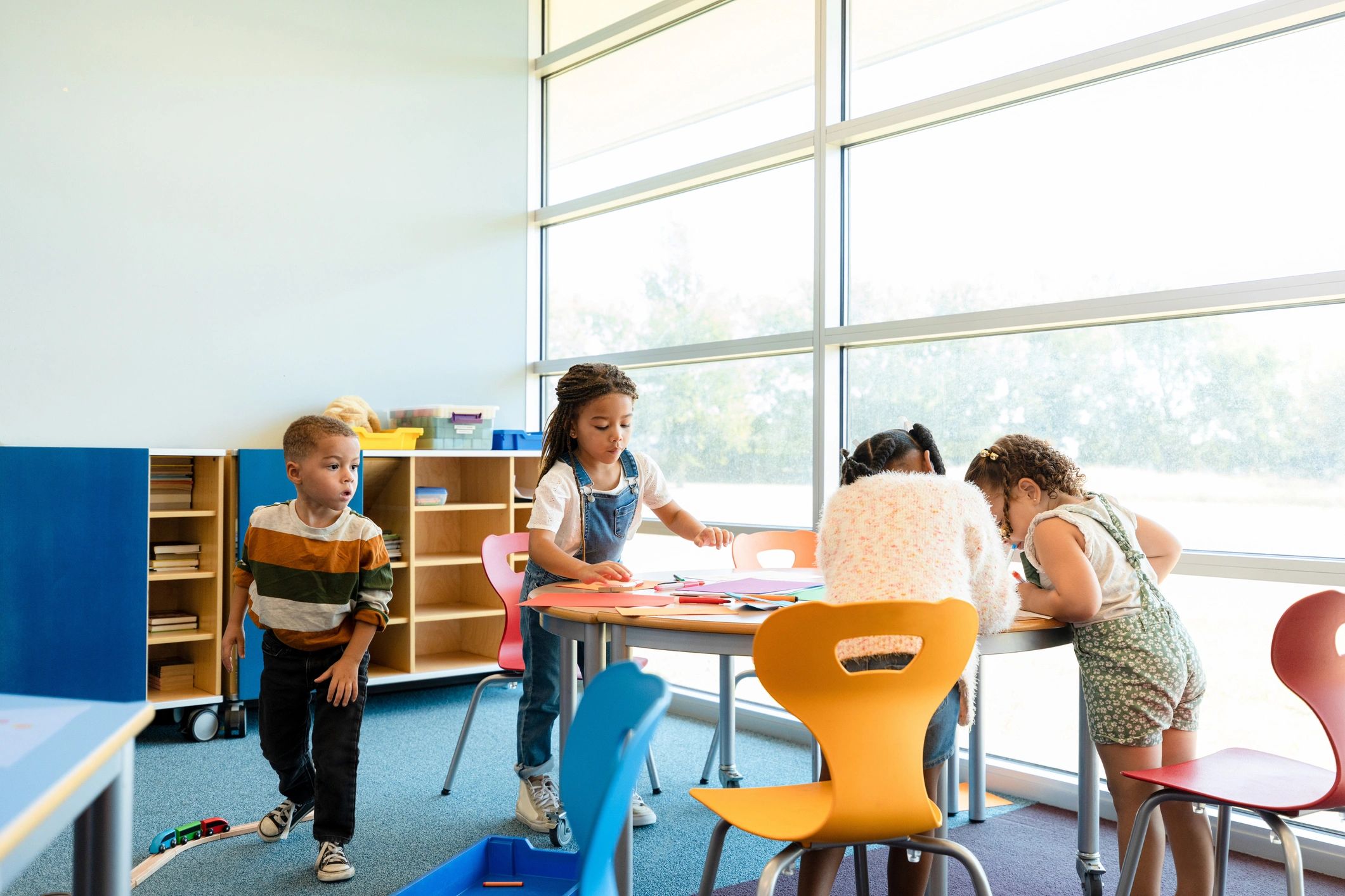 Children creating art together at a classroom table