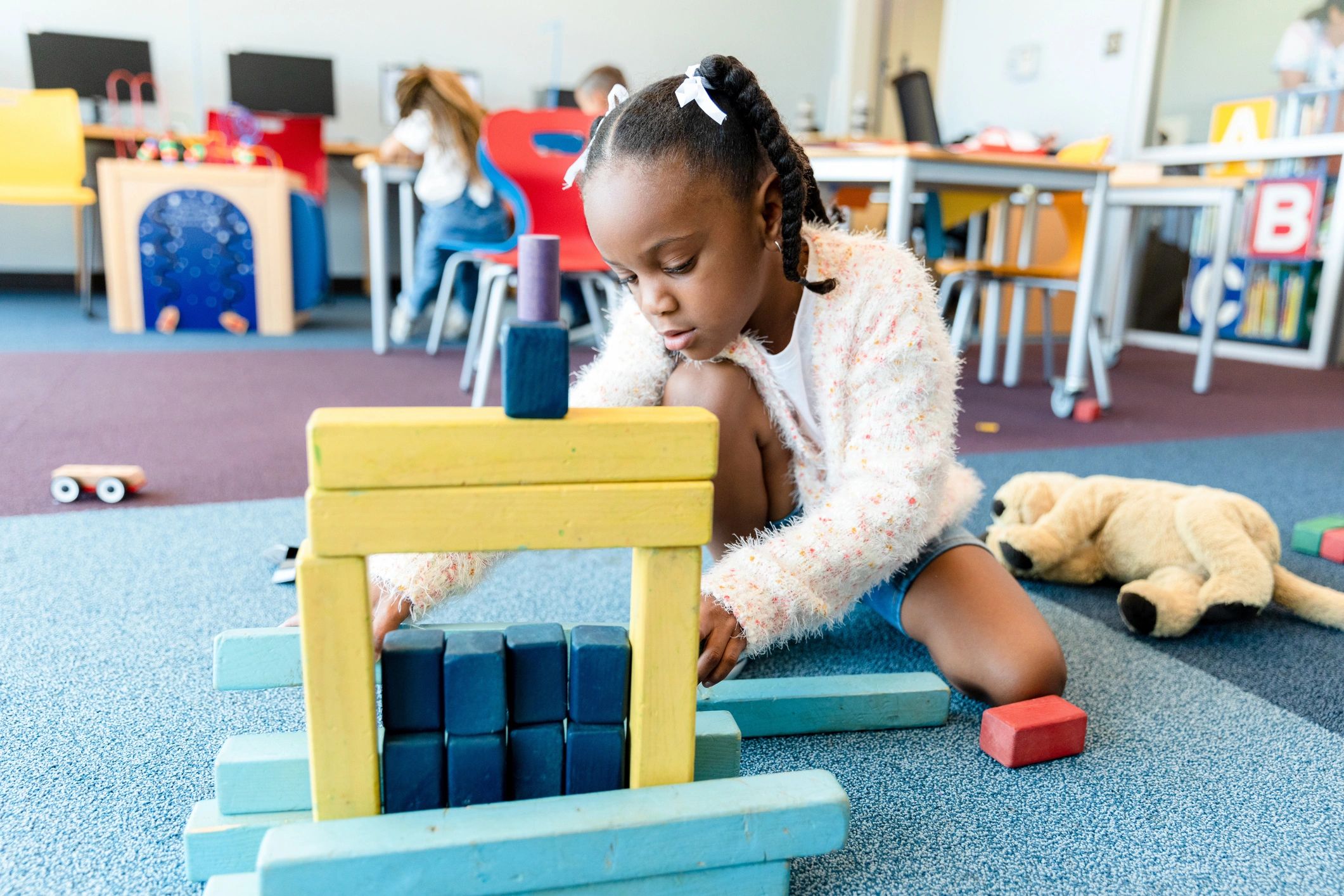 Toddler playing with wooden blocks on the floor