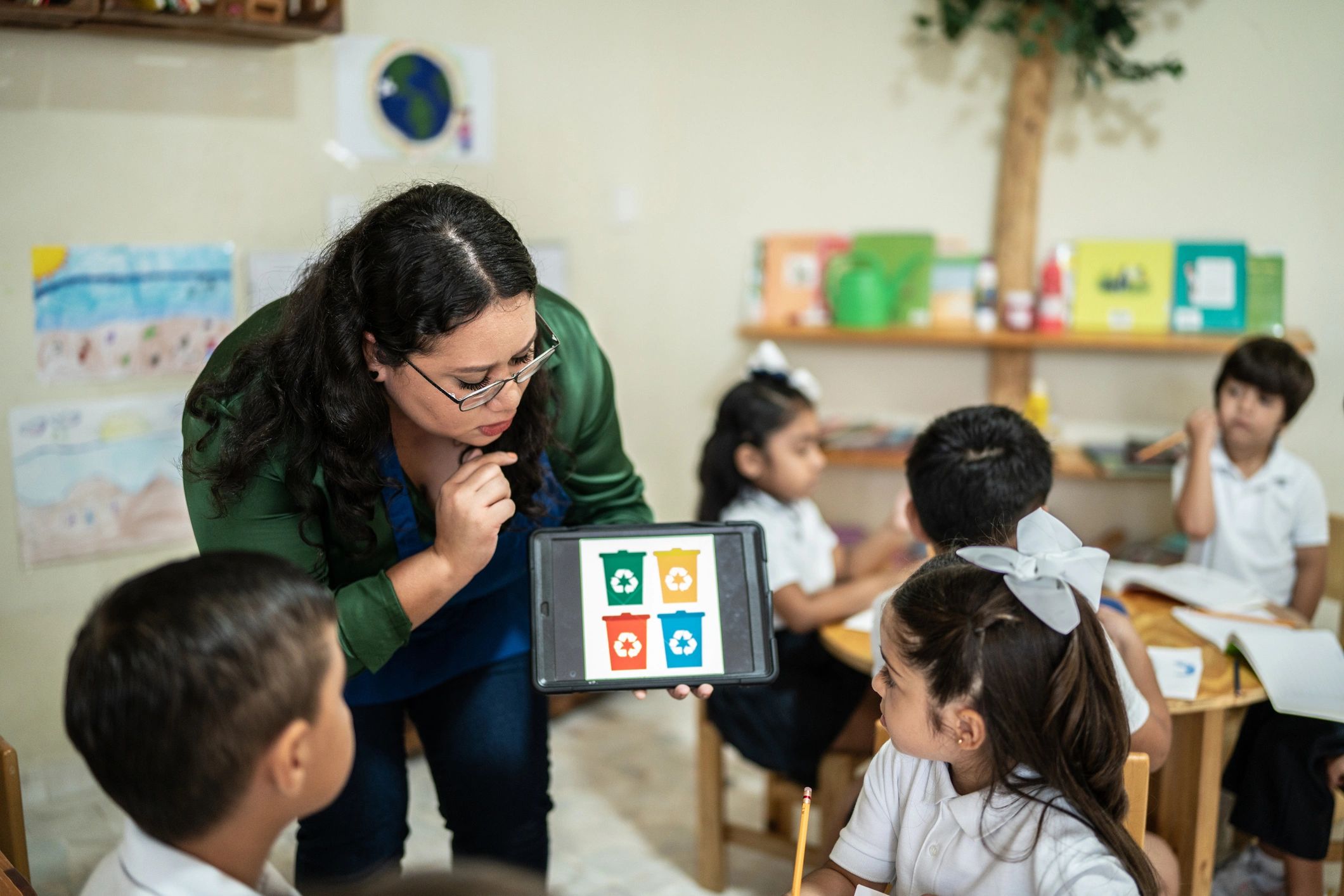 Teacher engaging with children in a bright classroom