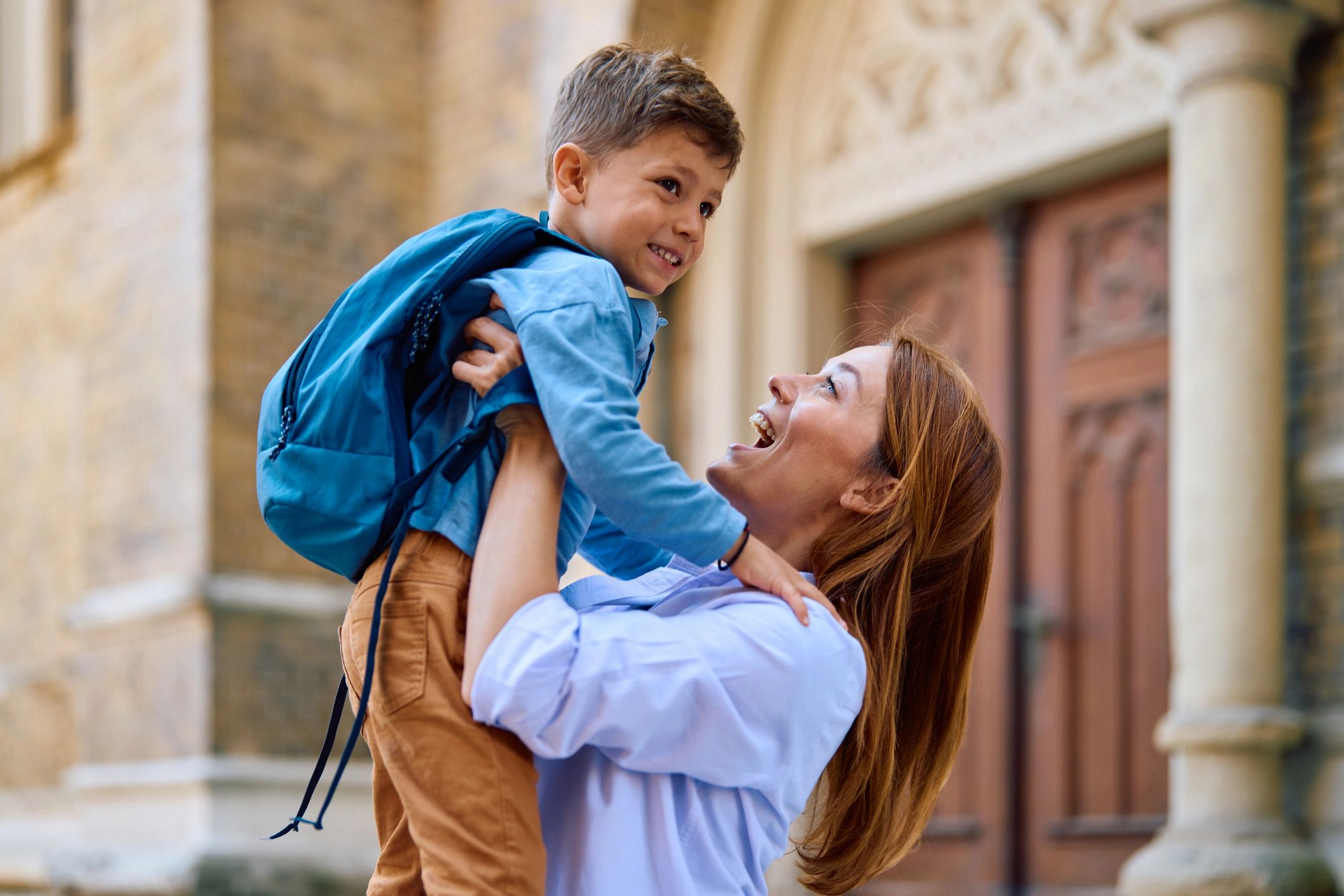 Parent and child sharing a happy drop-off moment