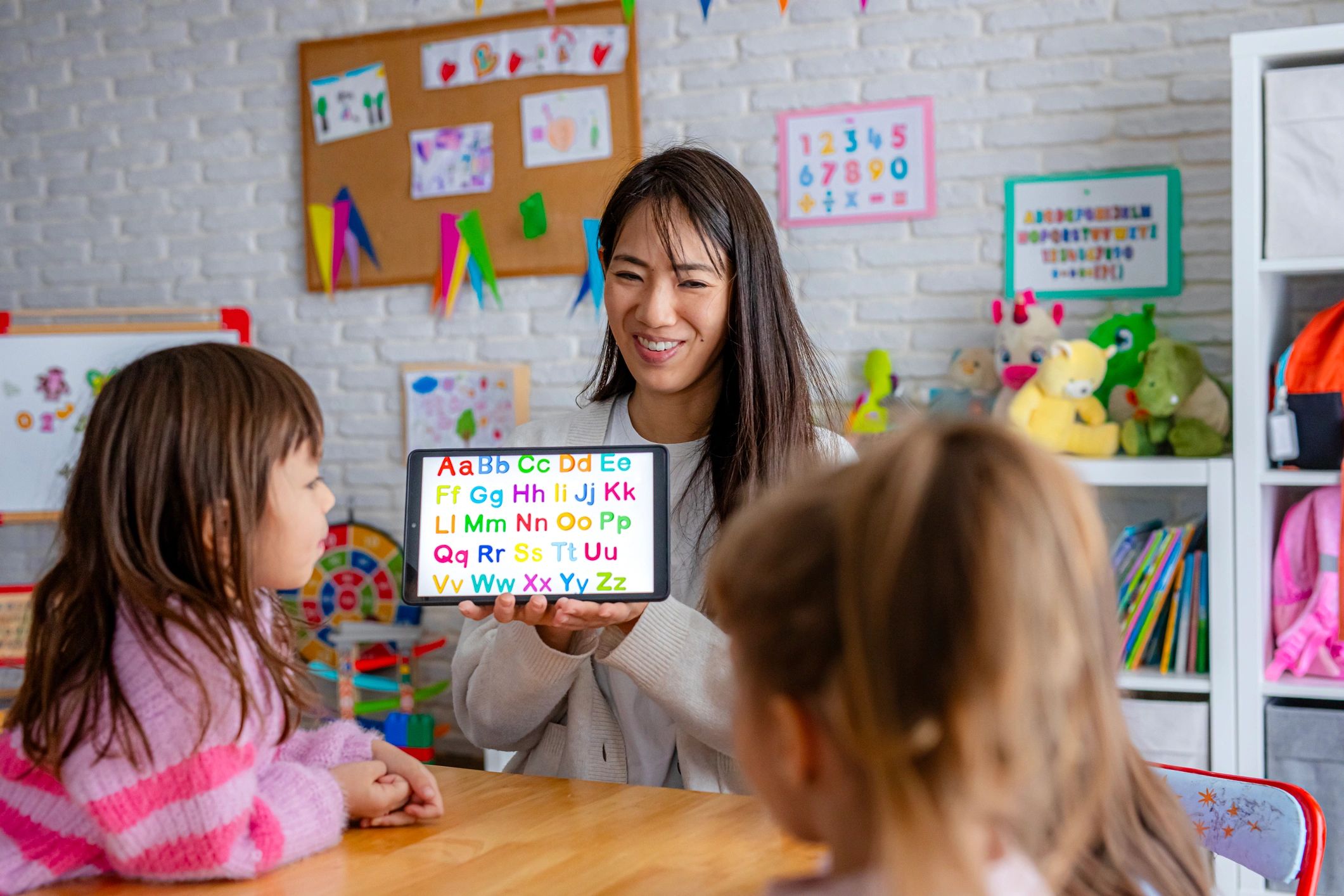 Teacher guiding children during an interactive classroom activity