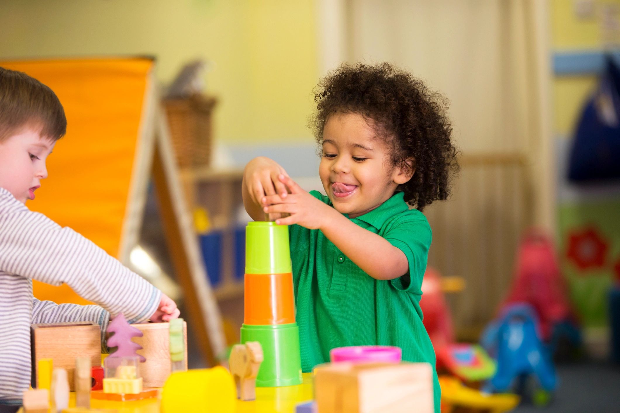 Two children playing with building blocks in a daycare